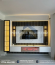 A contemporary living room showcasing smart storage with Custom TV wall unit, Floating cabinets, Fluted wall panels, Marble-effect TV background & LED lighting