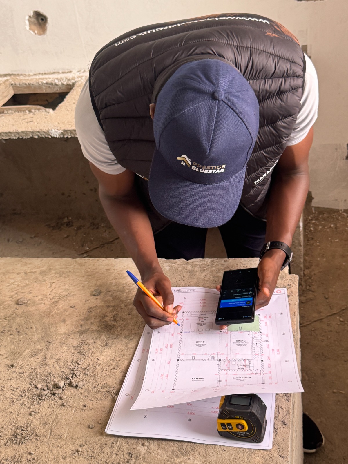 Are On-Site Consultations Charged? Here's Why | Prestige Bluestar 1 Professional interior designer conducting an on-site consultation before preparing a customized renovation quotation.